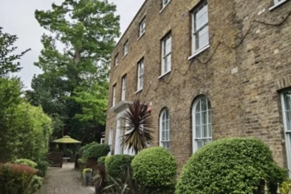 Beautiful brick facade and landscaped entrance of Bridge House Care Centre